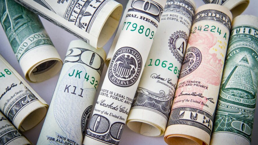 Close-up of rolled US dollar bills symbolizing wealth, financial success, and currency.